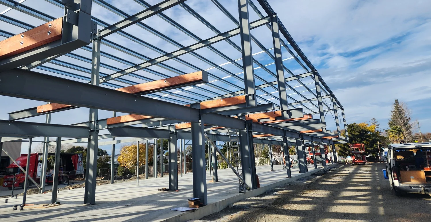 Steel portal frame with timber purlins under construction in Nelson